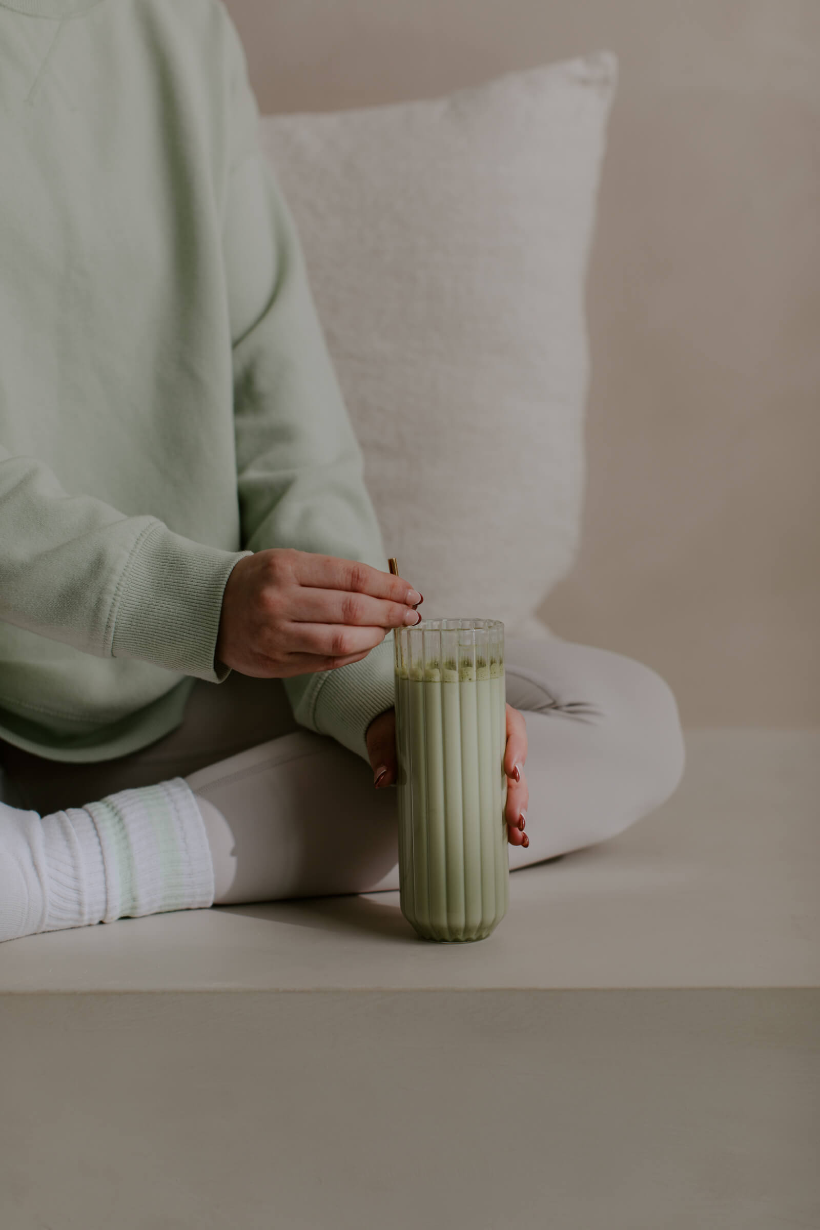 Woman coping with entrepreneur anxiety mindfully stirring a matcha late