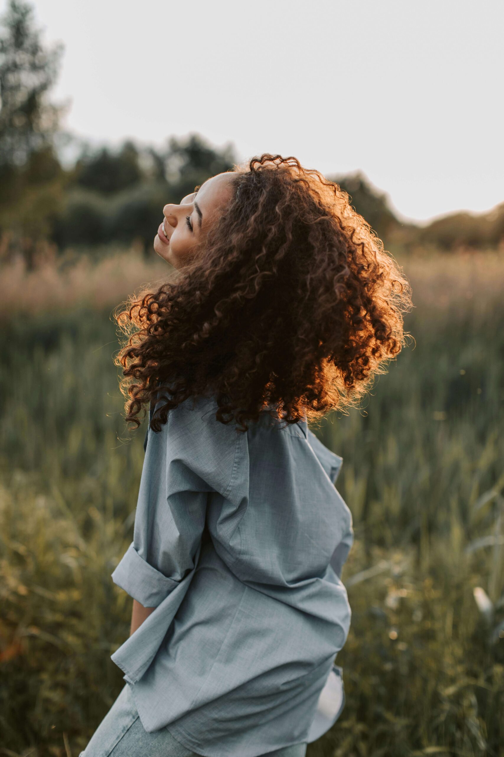 Authentic branding photography featuring a smiling female entrepreneur in a field