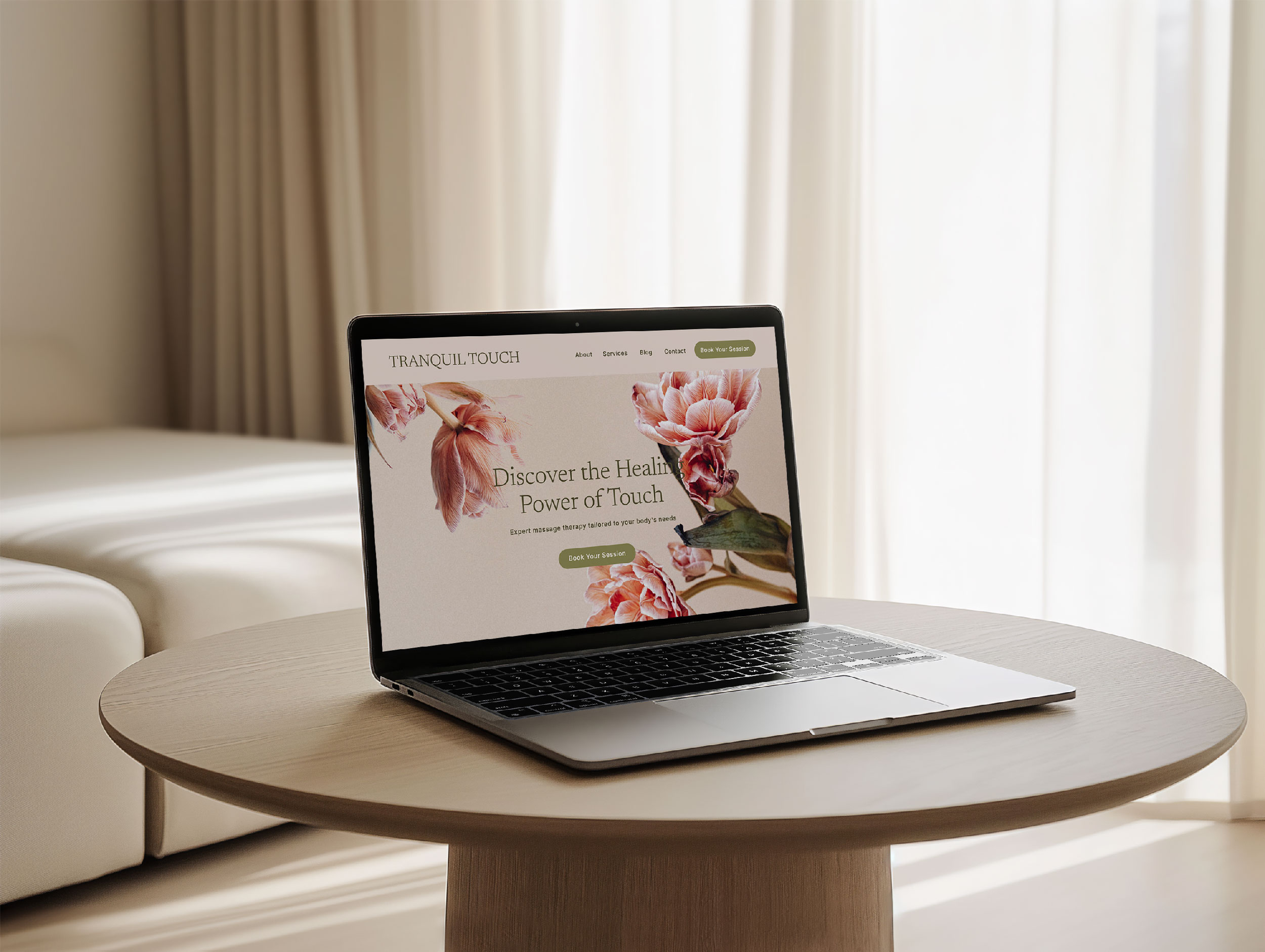 A laptop displaying a massage therapy Showit template with a floral design sits on a round wooden table in a softly lit room, enhanced by intuitive booking software for seamless appointments.